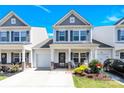 Charming two-story townhome with a covered porch, well-manicured landscaping, and a one-car garage at 103 Blackstone Ct # C, Statesville, NC 28677