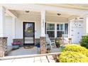 Inviting front porch featuring rocking chairs, potted plants, and decorative accents for a cozy and welcoming entrance at 103 Blackstone Ct # C, Statesville, NC 28677