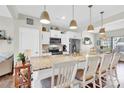 Stylish kitchen featuring a large center island with seating, granite countertops, and modern stainless steel appliances at 103 Blackstone Ct # C, Statesville, NC 28677
