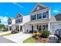 Attractive street view showcasing the townhome's curb appeal, tidy landscaping, and inviting covered porch at 103 Blackstone Ct # C, Statesville, NC 28677
