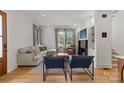 Bright living room with large windows, a fireplace, hardwood floors, and modern furnishings at 113 Prince St, Belmont, NC 28012