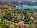 Beautiful aerial view of a lakeside home surrounded by colorful trees and waterfront views at 116 Ivy Hollow Ln, Mooresville, NC 28117