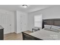 Cozy bedroom with neutral walls, wood-look floors, and a comfortable queen-sized bed at 123 E Farmview St, Gastonia, NC 28054