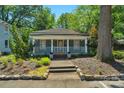 Inviting single-story home with a covered front porch and meticulously maintained landscaping at 1500 Pecan Ave, Charlotte, NC 28205