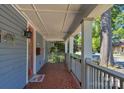 Charming covered front porch with patterned tile flooring and white railing at 1500 Pecan Ave, Charlotte, NC 28205