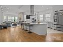 Open concept kitchen with stainless steel appliances, large island and hardwood floors at 2117 Middlebridge Ct, Fort Mill, SC 29715