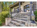 Close up of front entrance featuring stone steps, black railing, and a wreath-adorned double door at 2122 Goose Creek Farm Ln, Indian Trail, NC 28079