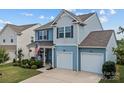 Charming two-story home with a well-manicured lawn and a two-car garage at 214 Hidden Lakes Rd, Statesville, NC 28677