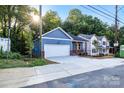Charming blue home with a garage and a newly poured driveway at 354 Moore Ave, Mooresville, NC 28115