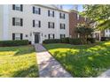 Stylish condo building with brick accents, black shutters, lush lawn, and well-maintained landscaping at 4024 Town Center Rd, Harrisburg, NC 28075