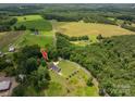 Expansive aerial shot of a charming home surrounded by lush greenery, offering a serene and private retreat at 4441 Jim Wise Rd, Lincolnton, NC 28092