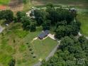 Stunning aerial view of a secluded home nestled among lush trees, showcasing its expansive yard and serene setting at 4441 Jim Wise Rd, Lincolnton, NC 28092