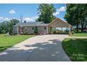Beautifully maintained home with an expansive driveway leading to a convenient carport, perfect for outdoor gatherings at 4441 Jim Wise Rd, Lincolnton, NC 28092
