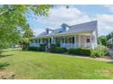 Beautiful home with a full front porch, dormer windows and luscious green lawn at 5211 Spring Gln, York, SC 29745