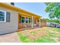 Close-up of the front porch with charming chairs and a well-manicured front yard at 701 Mcswain Rd, Shelby, NC 28150