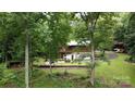 Secluded backyard featuring a patio, lush landscaping, and mature trees offering privacy and serenity at 720 Potneck Rd, Salisbury, NC 28147
