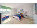 Cozy bedroom with a colorful bed, carpeted floors, and a large window for natural light at 7878 Old Brook Rd, Sherrills Ford, NC 28673