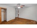 Bedroom with hardwood floors, closet, and ceiling fan offers a simple, comfortable space at 807 Claremont Rd, Charlotte, NC 28214