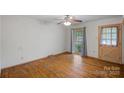 Bedroom featuring original hardwood floors, natural light, a ceiling fan, and classic charm at 807 Claremont Rd, Charlotte, NC 28214