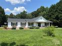 Beautiful single-story home with a covered porch and lush green lawn at 8122 Hutchison Ln, Vale, NC 28168