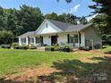 Charming ranch-style home featuring a covered porch, wooden pillars, and lovely landscaping at 8122 Hutchison Ln, Vale, NC 28168