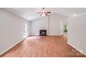 Bright living room features vaulted ceilings, wood-look flooring, fireplace, and large windows offering lots of natural light at 9000 Vagabond Rd, Charlotte, NC 28227