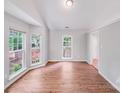 Open concept living room with lots of natural light, wood-look flooring and door leading to the backyard at 9000 Vagabond Rd, Charlotte, NC 28227