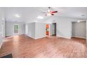Spacious living room features vaulted ceilings, wood-look floors, and neutral paint for versatile decorating options at 9000 Vagabond Rd, Charlotte, NC 28227