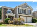 Charming two-story home with attached two-car garage and well-maintained landscaping in daytime at 9511 Turning Wheel Dr, Charlotte, NC 28214