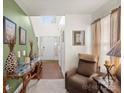 Bright foyer with hardwood floors, neutral walls, decorative table, and cozy armchair at 9511 Turning Wheel Dr, Charlotte, NC 28214