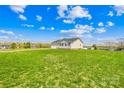 Spacious backyard with lush green lawn and views of neighboring properties at 103 Chambwood Ln, Shelby, NC 28152