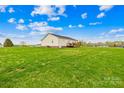 Expansive backyard with lush lawn and wooden deck, perfect for outdoor entertaining at 103 Chambwood Ln, Shelby, NC 28152
