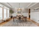 Elegant dining room featuring a chandelier, wainscoting, and a large window with natural light at 11008 Strike The Gold Ln, Waxhaw, NC 28173