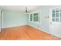 Bright dining room with hardwood floors, a light fixture, and a large window at 114 Larkfield Dr, Waxhaw, NC 28173