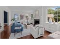 Inviting living room with a fireplace, ample natural light, and elegant furnishings at 117 N Central Ave, Belmont, NC 28012
