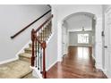 Inviting foyer with hardwood floors, staircase with rod iron spindles, and an arched entryway leading to the living area at 1314 San Gabriel Ave, Charlotte, NC 28214