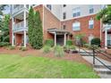 Well-maintained building entrance with lush landscaping and accessible ramp at 14451 San Paolo Ln, Charlotte, NC 28277