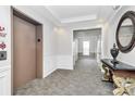 Bright condo hallway with elevator access and decorative table with mirror at 14451 San Paolo Ln, Charlotte, NC 28277