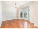 Spacious dining room with hardwood floors, a bay window, and modern light fixture at 14911 Taggert Trail Dr, Charlotte, NC 28273