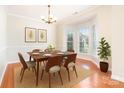 Elegant dining room featuring a bay window, modern lighting, and stylish decor at 14911 Taggert Trail Dr, Charlotte, NC 28273