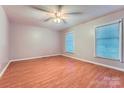 Bright bedroom with wood floors, a ceiling fan, and two windows for ample natural light at 1506 Union New Hope Rd, Gastonia, NC 28056