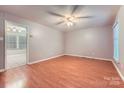 Spacious living room featuring wood floors, a ceiling fan, and natural light from a window at 1506 Union New Hope Rd, Gastonia, NC 28056