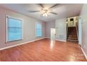 Open living room featuring wood floors, two windows and access to the staircase at 1506 Union New Hope Rd, Gastonia, NC 28056
