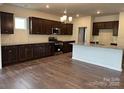 Modern kitchen with dark cabinets, stainless steel appliances, and a large center island at 160 Ella Claire Dr, York, SC 29745