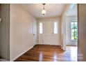 Bright foyer with hardwood floors, a coat closet, and a view to the front door at 1658 Buckingham Ave, Gastonia, NC 28054