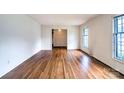 Spacious living room with hardwood floors, large windows, and bright white walls at 1658 Buckingham Ave, Gastonia, NC 28054