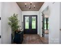 Welcoming foyer with hardwood floors, stylish rug, and elegant decor at 176 Windwood Ln, Troutman, NC 28166