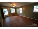 Spacious living room with hardwood floors, a ceiling fan, and natural light from the windows at 201 W 19Th St, Kannapolis, NC 28081