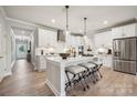 Modern kitchen with white cabinets, stainless appliances, and a center island with seating at 2026 Mantle Ridge Dr, Indian Trail, NC 28079