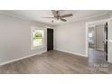 Inviting living room featuring fresh paint, a black interior door, and durable laminate floors throughout at 210 Marshall St, Rock Hill, SC 29730